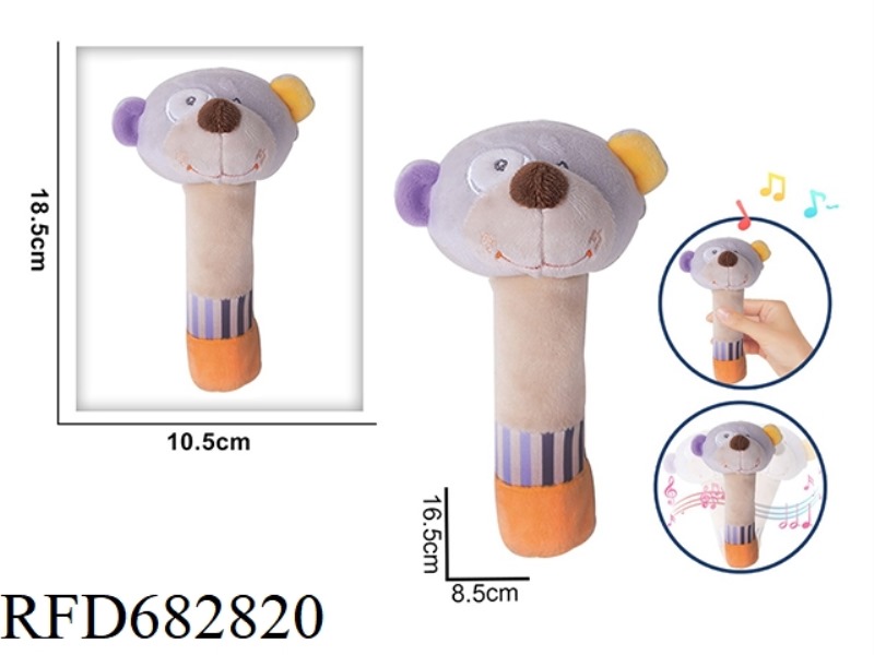 THE LITTLE BEAR IS HOLDING A RATTLE, A BB STICK AND A PLUSH SOOTHING TOY
