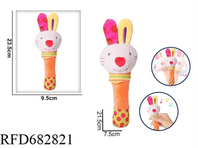 THE LITTLE RABBIT IS HOLDING A RATTLE BB STICK AND PINCHING A PLUSH SOOTHING TOY
