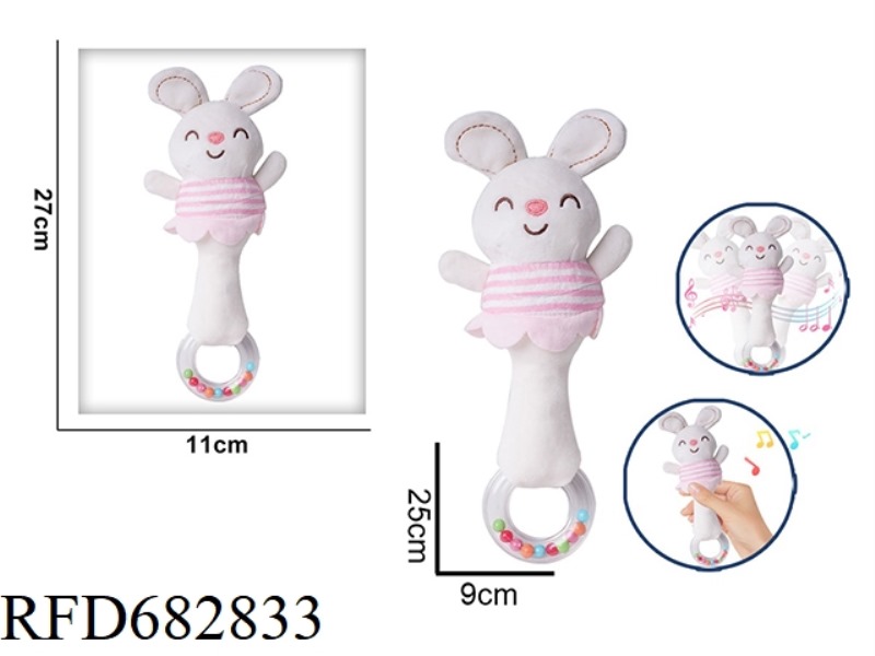 A WHITE RABBIT IS HOLDING A RATTLE BB STICK AND A PLUSH SOOTHING TOY